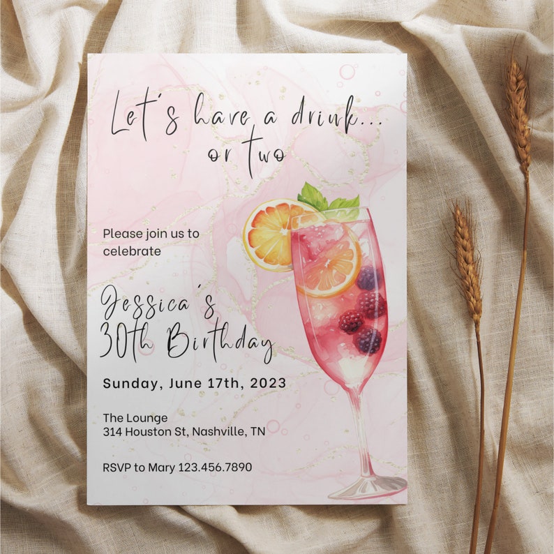 May include: Pink and gold birthday invitation with a watercolor illustration of a cocktail glass with fruit and berries. The text reads "Let's have a drink... or two. Jessica's 30th Birthday. Sunday, June 17th, 2023. The Lounge. 314 Houston St, Nashville, TN. RSVP to Mary 123.456.7890"