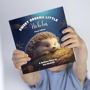 May include: A blue book with the title "Sweet Dreams Little Nicholas - Forest Edition -" and a picture of a hedgehog on the cover. The book says "A Bedtime Story by Ersi Nicholls" at the bottom.