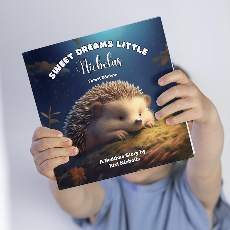 May include: A blue book with the title "Sweet Dreams Little Nicholas - Forest Edition -" and a picture of a hedgehog on the cover. The book says "A Bedtime Story by Ersi Nicholls" at the bottom.