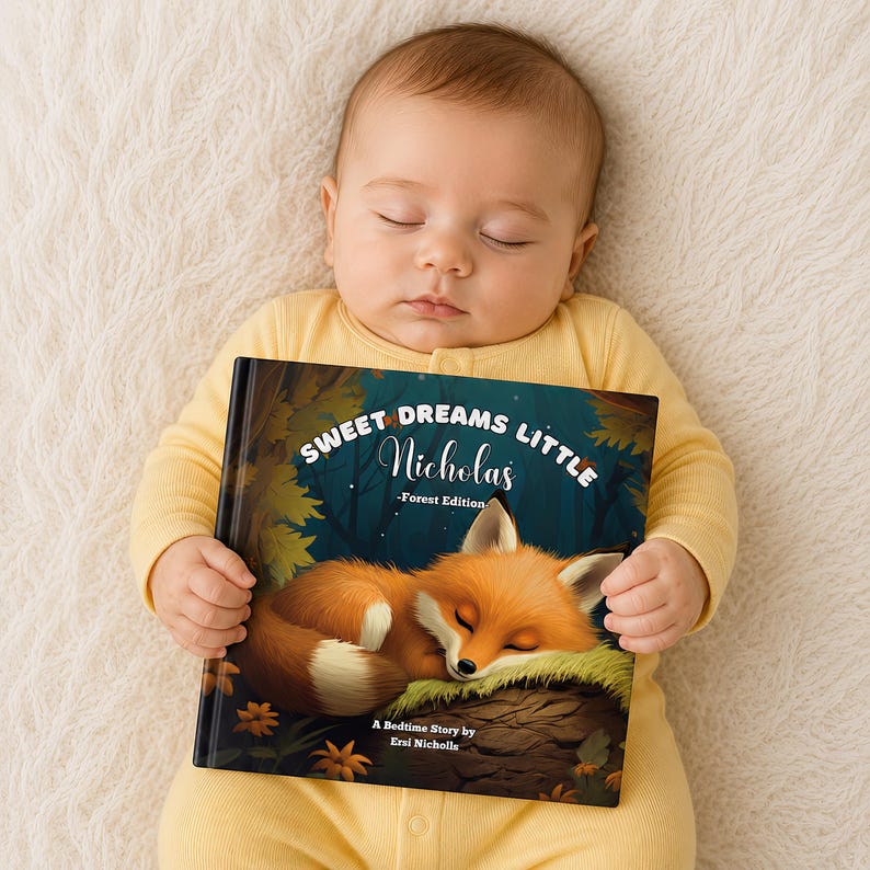 May include: A hardback children's book titled Sweet Dreams Little Nicholas - Forest Edition, featuring an illustration of a sleeping fox on a log. The cover includes the text Sweet Dreams Little Nicholas - Forest Edition and A Bedtime Story by Ersi Nicholls, set against a dark forest background with autumn leaves.