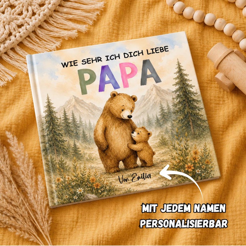 May include: A children's book with the title "Wie Sehr Ich Dich Liebe Papa" featuring a watercolor illustration of a bear and cub in a forest setting. The text "Mit jedem Namen Personalisierbar" is also visible.