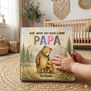 May include: A children's book with the German text "WIE SEHR ICH DICH LIEBE PAPA" and a watercolor illustration of a bear and a cub in a forest setting. The book cover has a soft, pastel color palette and the text "Von Emilia".