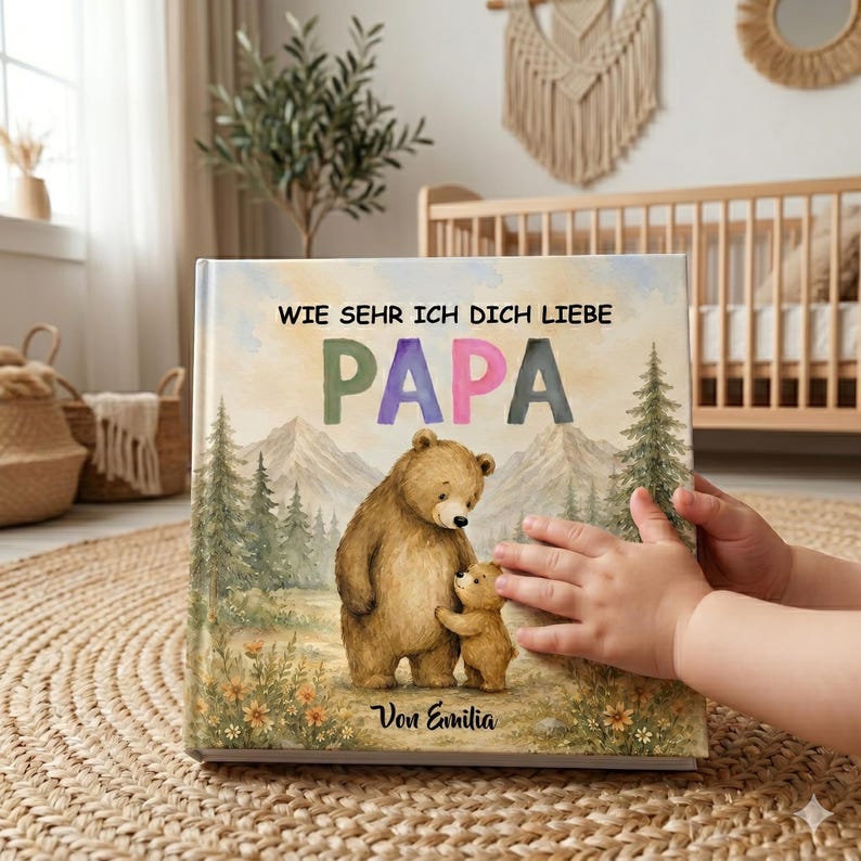May include: A children's book with the German text "WIE SEHR ICH DICH LIEBE PAPA" and a watercolor illustration of a bear and a cub in a forest setting. The book cover has a soft, pastel color palette and the text "Von Emilia".