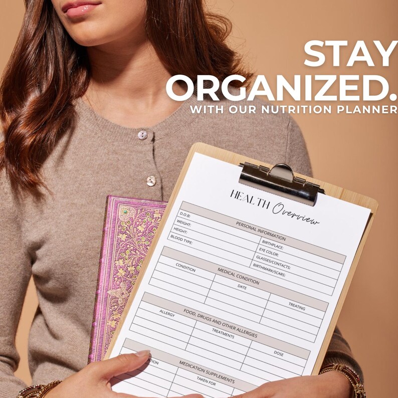 May include: A white clipboard with a brown wooden frame, labeled "HEALTH Overview". The clipboard has a checklist for personal information, medical conditions, food allergies, and medication supplements. The clipboard is held by a person wearing a brown sweater.