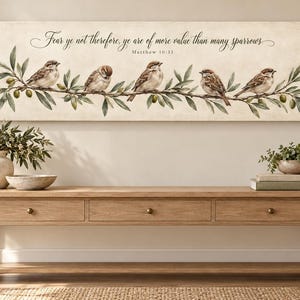 May include: A rectangular wall art canvas featuring five brown sparrows perched on an olive branch with green leaves and small olives. The text reads: Fear ye not therefore, ye are of more value than many sparrows. Matthew 10:31.