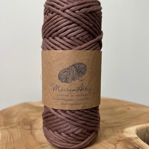 Può includere: Un rotolo di cordoncino di cotone marrone per progetti di macramè. L'etichetta recita "Macram'AkkiZ L'UNIVERS DU MACRAME Corde Macrame 100% Coton Qualite premium".