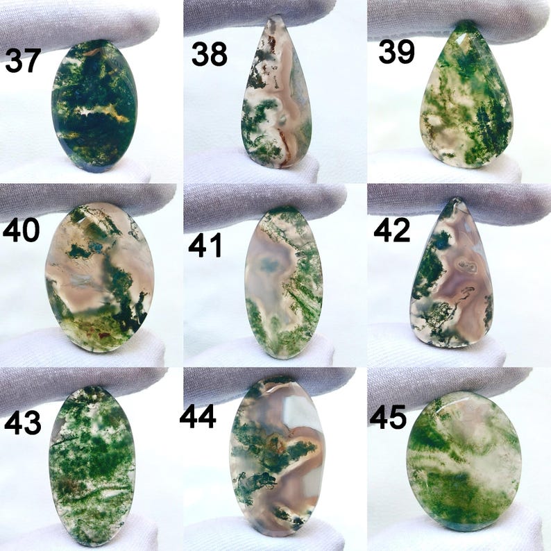 May include: Nine polished moss agate gemstones in various shapes, including oval and teardrop. The stones display a range of colors, with green moss-like inclusions against a translucent or milky background. Each stone is numbered from 37 to 45.