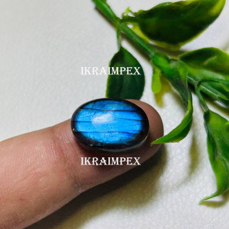 May include: A blue oval-shaped labradorite gemstone with iridescent flashes of color. The gemstone is set in a silver ring.
