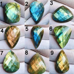 May include: Nine faceted labradorite gemstones in various shapes. The stones display a range of colors, including blues, greens, and golds, with iridescent flashes. Each stone is unique, showcasing natural patterns and cuts.