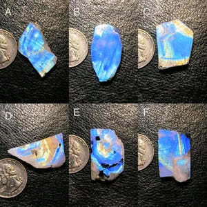 May include: Six pieces of iridescent labradorite gemstone, each with a unique pattern of blue and green hues. The stones are displayed next to US quarter coins for size comparison.