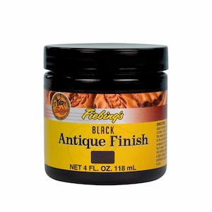 May include: A black jar of Fiebing's Black Antique Finish leather dye. The jar is labelled with the product name and size: 118 ml (4 fl. oz).