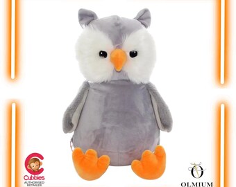 May include: A plush owl toy featuring soft grey fur on the body and wings, with white fluffy fur around the eyes. The owl has a bright orange beak and matching orange feet. The toy includes a Cubbies Authorised Retailer logo and an Olmium logo.