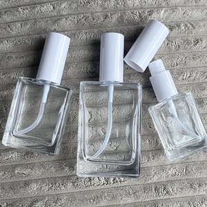 Square white spray or pump cap glass spray bottles. Perfume bottle, mist bottle, fragrance bottle, room spray bottle. Available in wholesale