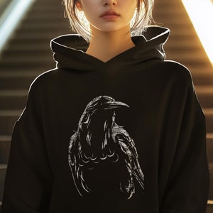 May include: Black hoodie with a white silhouette of a crow on the front.