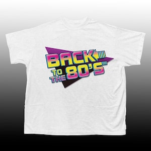Może przedstawiać: Biała koszulka z nadrukiem graficznym w postaci fioletowego, różowego i żółtego trójkąta z tekstem "Back to the 80's" w retro czcionce.