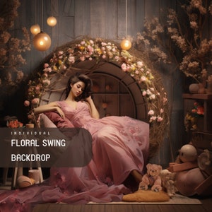 May include: A woman in a pink dress sits on a floral swing backdrop. The swing is decorated with pink flowers and greenery. The background is a rustic wooden wall with string lights.