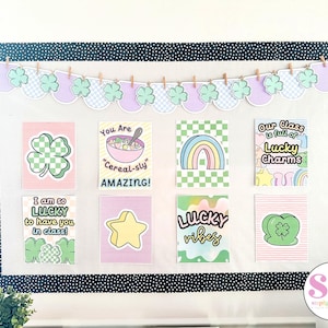 May include: A classroom bulletin board decorated with a green shamrock theme for St. Patrick's Day. The board has a black and white polka dot border and a garland of green shamrocks and purple scalloped shapes. The board is decorated with eight colorful printable signs with phrases like "I am so lucky to have you in class!" and "Our class is full of lucky charms".