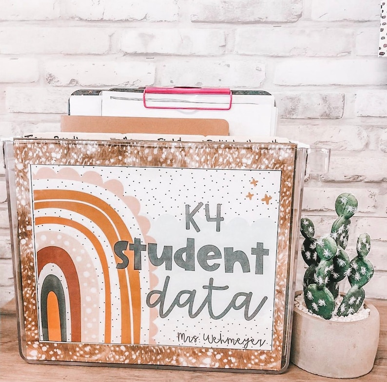 May include: A clear plastic file box with a colorful rainbow design and the text "K4 student data Mrs. Wehmeyer".