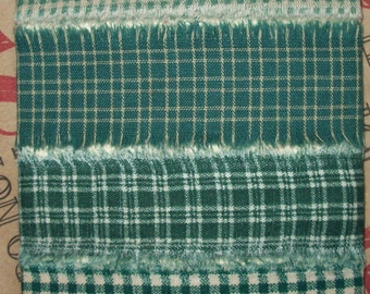 May include: Four different green and white plaid ribbons with frayed edges. The ribbons are arranged vertically on a white background.