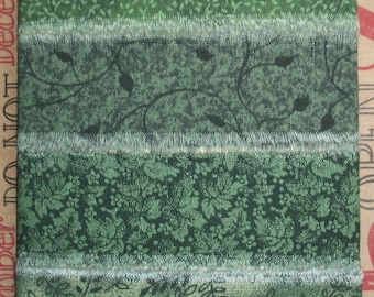 May include: Four different green ribbon trims with various patterns, including leaves, vines, and floral designs. The ribbons have a frayed edge and are perfect for crafting and decorating.
