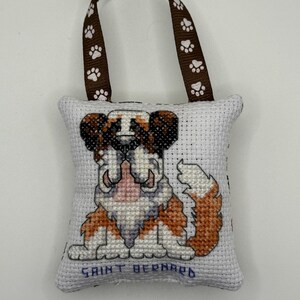 Cross stitched and stuffed holiday decoration of a Saint Bernard dog pillow ornament