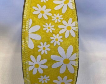 May include: A roll of yellow ribbon with a white daisy print.