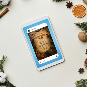 May include: A digital tablet displays a Halloween party invitation with bats, crows, and pumpkins. The invitation reads "Join us for a Halloween Party" with the date "Oct 31 6 PM". The tablet is surrounded by festive decorations including pine, cinnamon sticks, and dried orange slices.