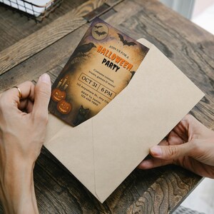 May include: A Halloween party invitation card in a beige envelope. The card features a spooky design with pumpkins, bats, and a raven. The text reads "Join Us For A Halloween Party" and includes the date, time, and address.
