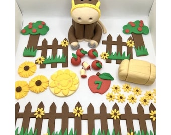 May include: A brown horse figurine with a yellow bridle, surrounded by fondant decorations including a fence, sunflowers, apples, a hay bale, and a sun. The number 7 is on a red apple.