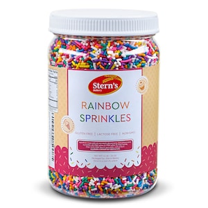 May include: A clear plastic jar filled with colorful rainbow sprinkles. The jar has a white lid and a label that reads "Stern's Bakery Rainbow Sprinkles Gluten Free | Lactose Free | Non-GMO Net Wt 1.5 LB - 24 OZ Packaged by: Stern's Bakery Store in a cool dry place."