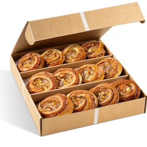 May include: A cardboard box with a lid, containing twelve baked pastries. The pastries are golden brown, swirled, and filled with a light-colored, sweet filling. The box is divided into three rows of four pastries each.
