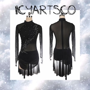 May include: Black figure skating dress with long mesh sleeves and rhinestone detailing. The dress has a high neckline and a skirt with a layered, flowing design. The text "ICYARTSCO" is at the top of the image.