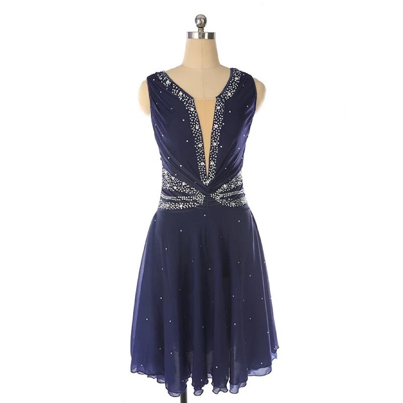May include: A navy blue sleeveless dress with a V-neckline and a beaded design around the waist. The dress has a flowing skirt and is adorned with rhinestones.