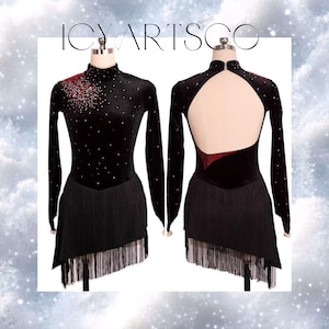 May include: Black velvet figure skating dress with a high neck, long sleeves, and a fringe skirt. The dress has a red velvet accent on the back and a keyhole opening.