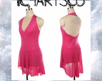 May include: A hot pink figure skating dress with a V-neck and rhinestone embellishments. The dress has a halter top and a flowing skirt. The back of the dress features a crisscross rhinestone design. The text "ICYARTSCO" is at the top.