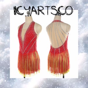 May include: A red dance costume with a deep V-neck and open back, adorned with silver rhinestones and a fringe hemline. The costume is displayed on a mannequin, showcasing its design and details. The text "ICYARTSCO" is written at the top.