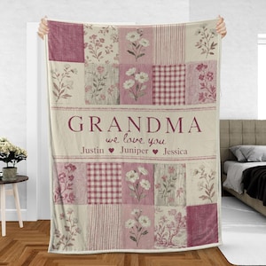 May include: A patchwork blanket with floral and gingham patterns in shades of pink and cream. The word "GRANDMA" is displayed prominently, with the phrase "we love you" and three names below.