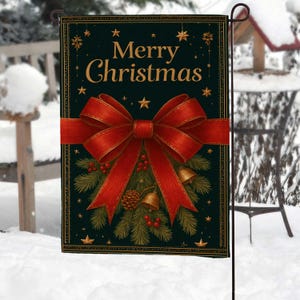 May include: A rectangular garden flag with a dark green background and gold text that reads "Merry Christmas." A large red bow is centered on the flag, with pine branches, berries, bells, and a pinecone below. The flag is displayed outdoors in a snowy setting.