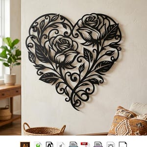 Puede incluir: Una pieza de arte mural de metal negro con forma de corazón, que presenta intrincados diseños recortados de dos rosas en flor con enredaderas y hojas entrelazadas. El objeto decorativo está montado en una pared lisa, mostrando una silueta floral.