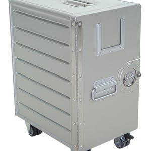 May include: A silver metal storage cart with a handle on top and a hinged door. The cart has horizontal ridges on the front and is mounted on four caster wheels. A metal handle is on the side.