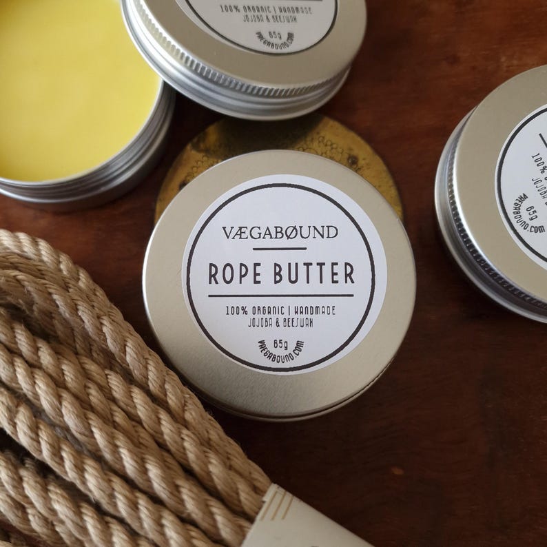 a collection of vegan-friendly products, including a tin of rope butter and a rope handle, arranged on a wooden surface.