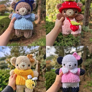 May include: Four crocheted plush toys, each with a different outfit and accessories. The first is a brown bear wearing a blue dress and a blue bow. The second is a brown bear wearing a pink dress and a red strawberry hat. The third is a brown bear wearing a yellow sweater and a bee. The fourth is a black and white panda wearing a pink sweater and a pink bow.