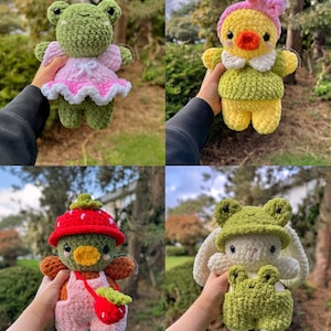 May include: Four crocheted plush toys in different outfits. A green frog wearing a pink dress, a yellow duck wearing a green shirt, a green frog wearing a red strawberry hat and pink overalls, and a white bunny wearing a green frog hat and green overalls.