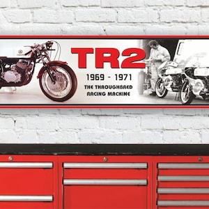 Könnte beinhalten: Ein rotes und weißes Yamaha TR2 Motorrad-Rennbanner mit dem Text "TR2 1969 - 1971 THE THOROUGHBRED RACING MACHINE".