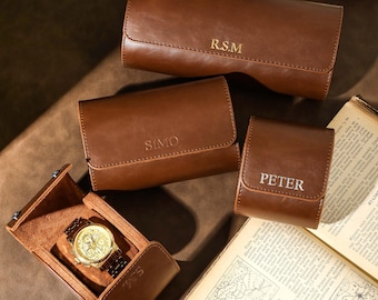 May include: Four brown leather watch boxes with gold lettering. The boxes are personalized with the names "R.S.M", "SIMO", "PETER", and "S.M".