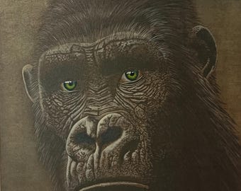 May include: A detailed portrait of a gorilla with striking green eyes. The artwork is rendered in shades of brown and black, creating a realistic depiction of the animal's fur and facial features. The painting is displayed on a wall.