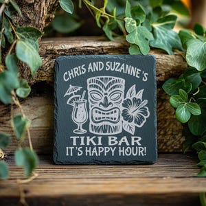 May include: A black slate sign with white text that reads "Chris and Suzanne's Tiki Bar It's Happy Hour!" The sign features a tiki head with a flower and a cocktail glass.