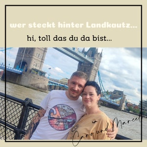 May include: A couple poses in front of Tower Bridge in London, England. The man is wearing a white t-shirt with a graphic design that says "In My Element". The woman is wearing a beige shirt. The text "Caro und Marcel" is written in cursive on the bottom right of the image.