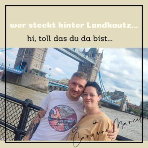 May include: A couple poses in front of Tower Bridge in London. The man is wearing a white t-shirt with a graphic design and the text "IN MY CEMENT". The woman is wearing a beige shirt with the text "Caro und Marcel" written on it.