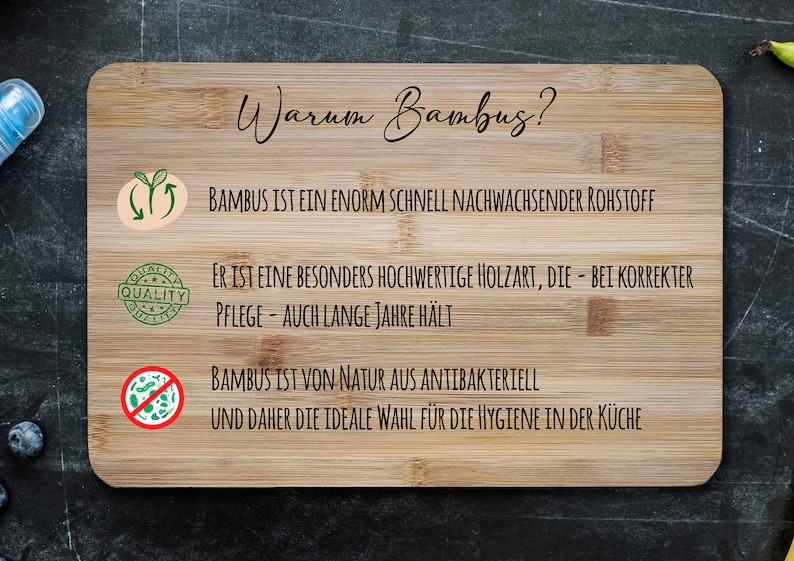 May include: A wooden cutting board with the text "Warum Bambus?" and three bullet points explaining the benefits of bamboo. The bullet points are: "Bamboo is a fast-growing raw material", "It is a high-quality wood that lasts for years with proper care", and "Bamboo is naturally antibacterial, making it ideal for kitchen hygiene."